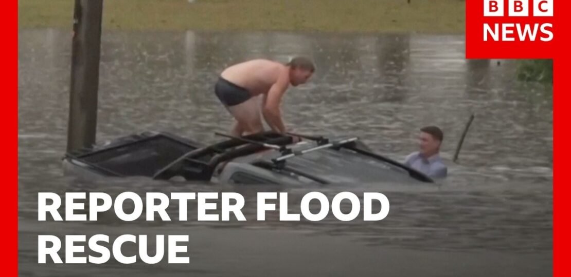 Reporter swims through flood to rescue man from sinking car | BBC News
